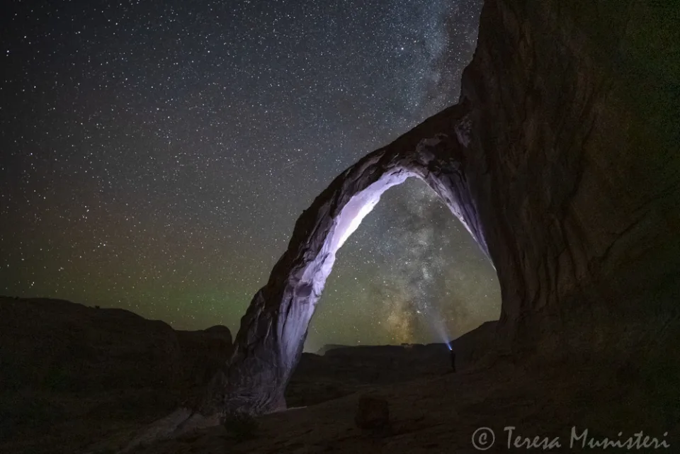 The Milky Way arching over a natural sandstone arch at night near Moab, Utah