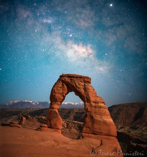 Delicate Arch beneath the Milky Way and the La Sal Mountains