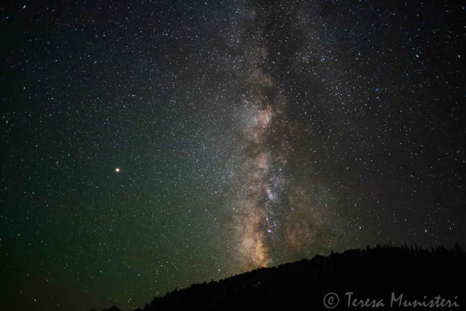 The core of the Milky Way rising over a dark desert ridgeline