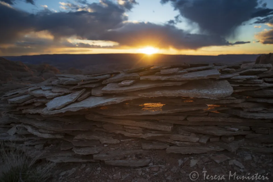 Sunset over layered sandstone slabs
