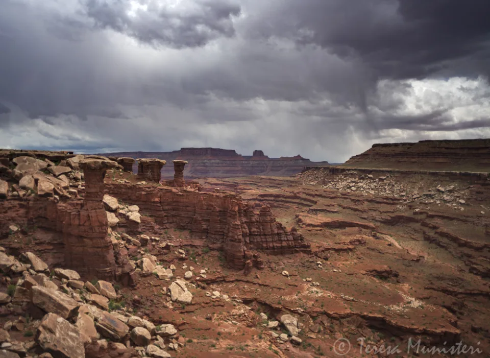 Ancestral stone ruin on a canyon rim under storm light
