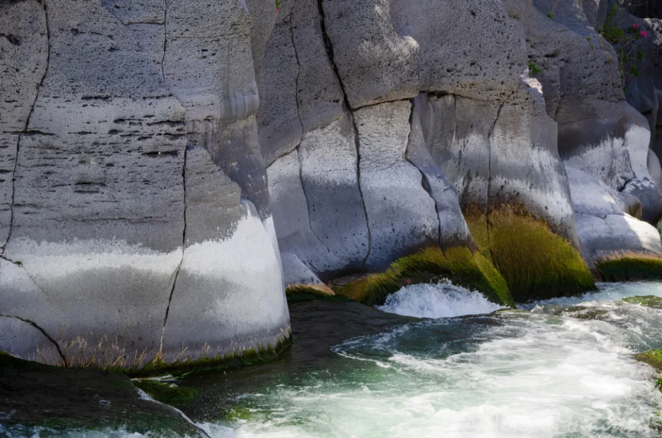 Whitewater running between banded rock walls