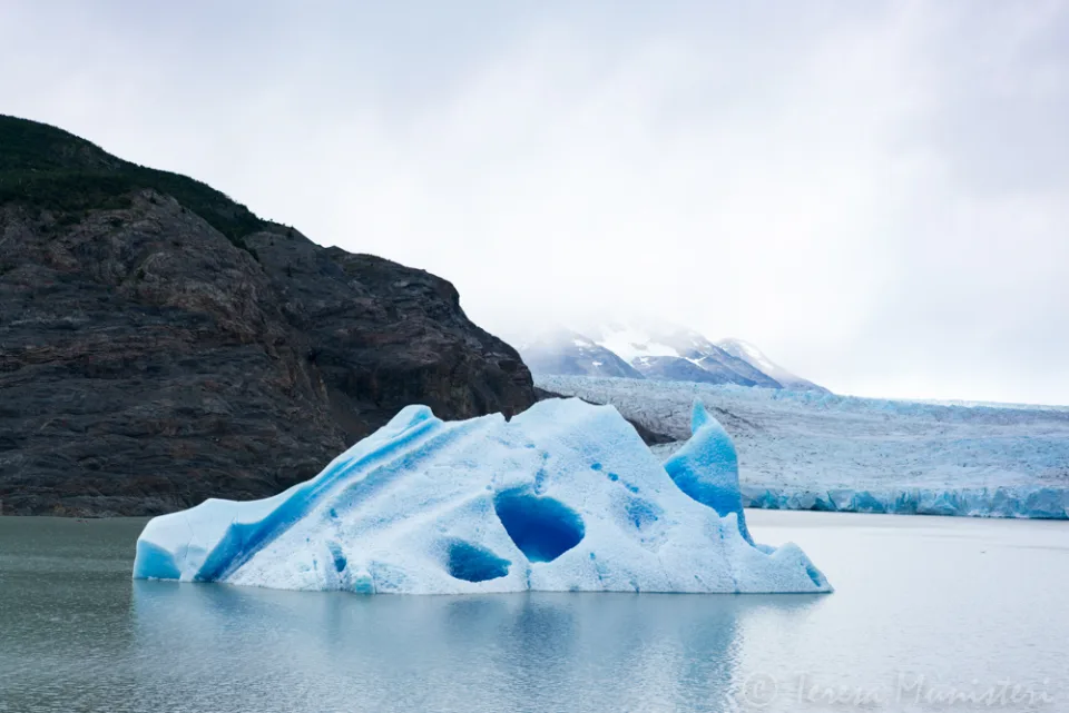 An iceberg floating on a glacial lake